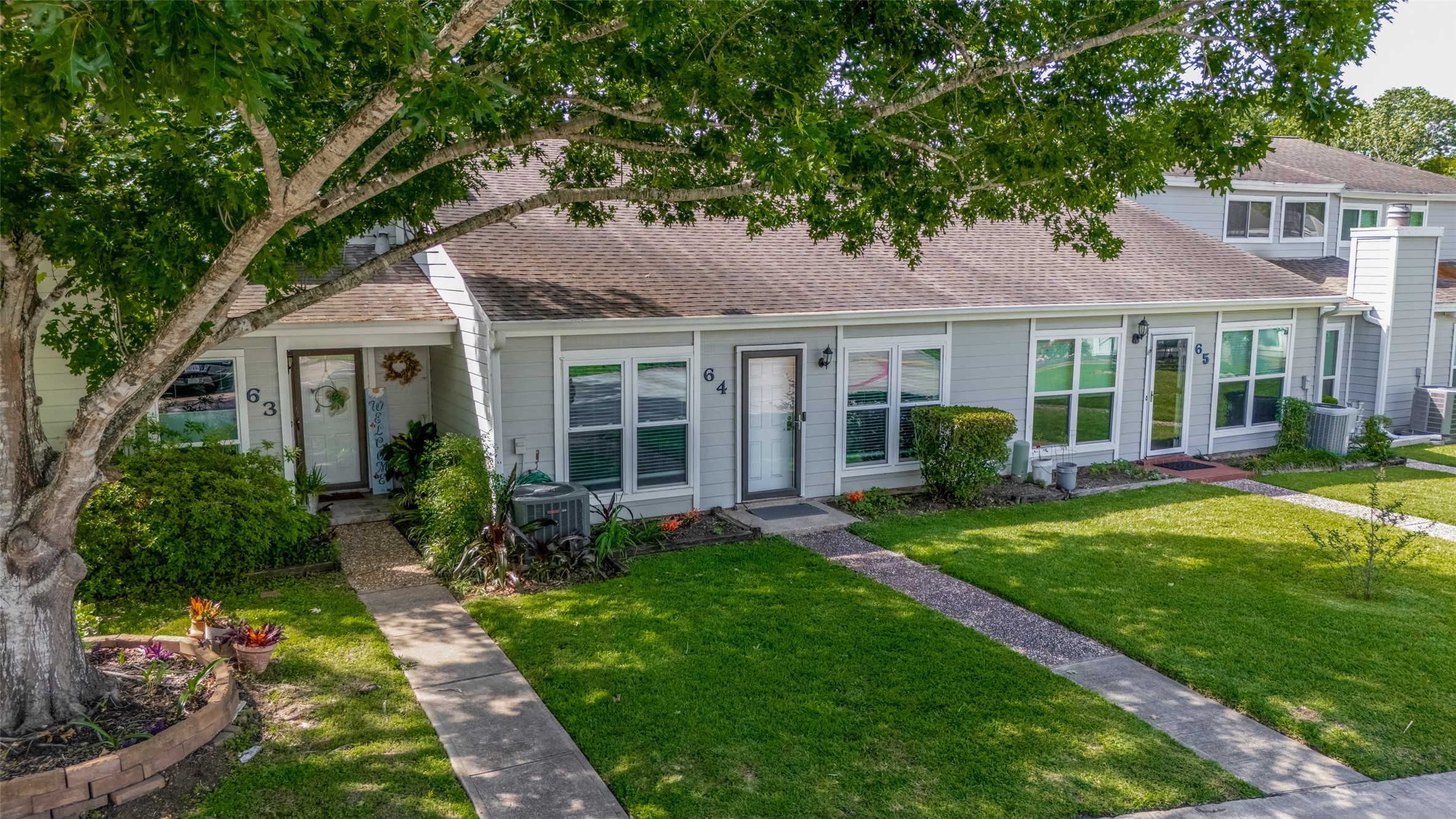 64 Hideaway Drive Friendswood, TX 77546 - Photo 30 of 33 a front view of a house with a yard and porch
