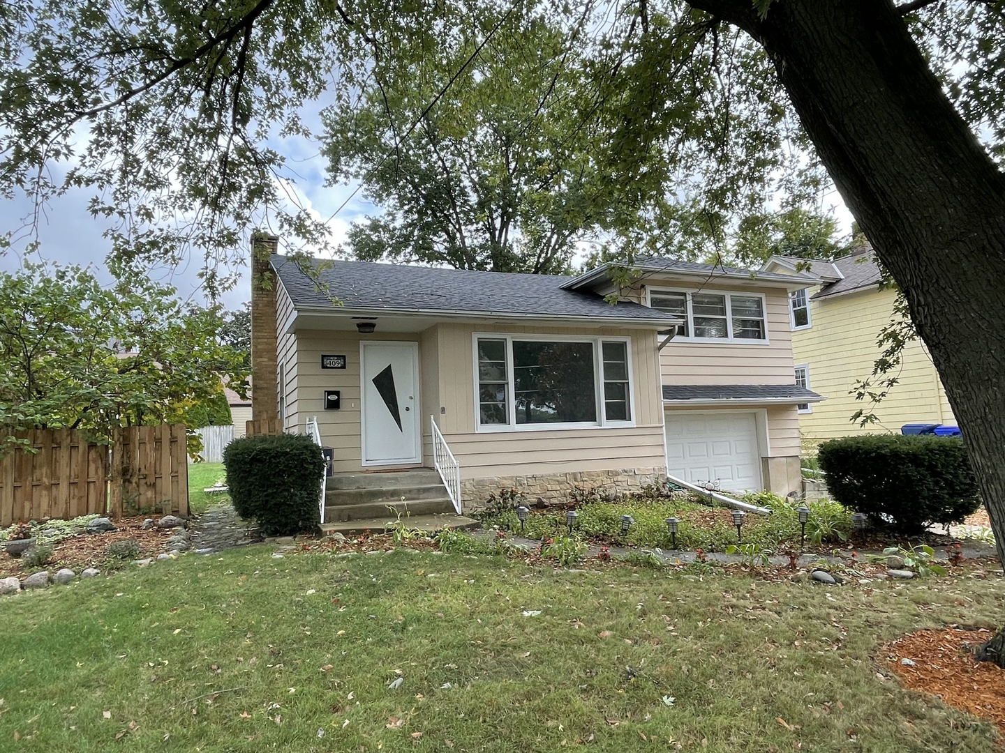 409 South Naperville Road Wheaton, IL 60187 - Photo 1 of 11 a front view of a house with a garden