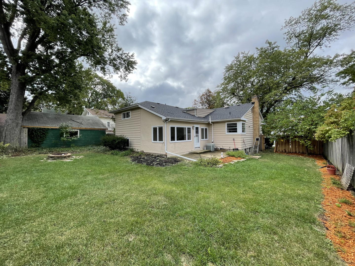 409 South Naperville Road Wheaton, IL 60187 - Photo 3 of 11 a view of a house with a backyard
