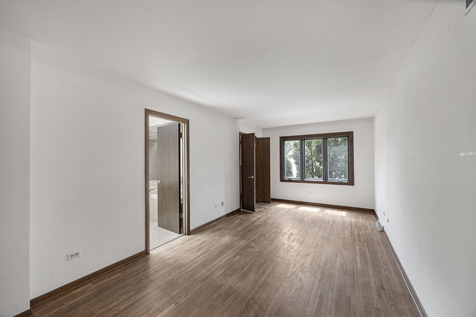 6723 Kingswood Road Willowbrook, IL 60527 - Photo 25 of 51 an empty room with wooden floor and windows