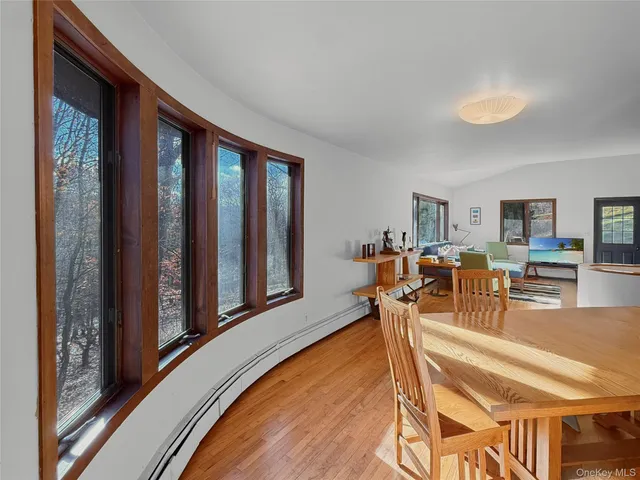 a view of a dining room with furniture window and wooden floor