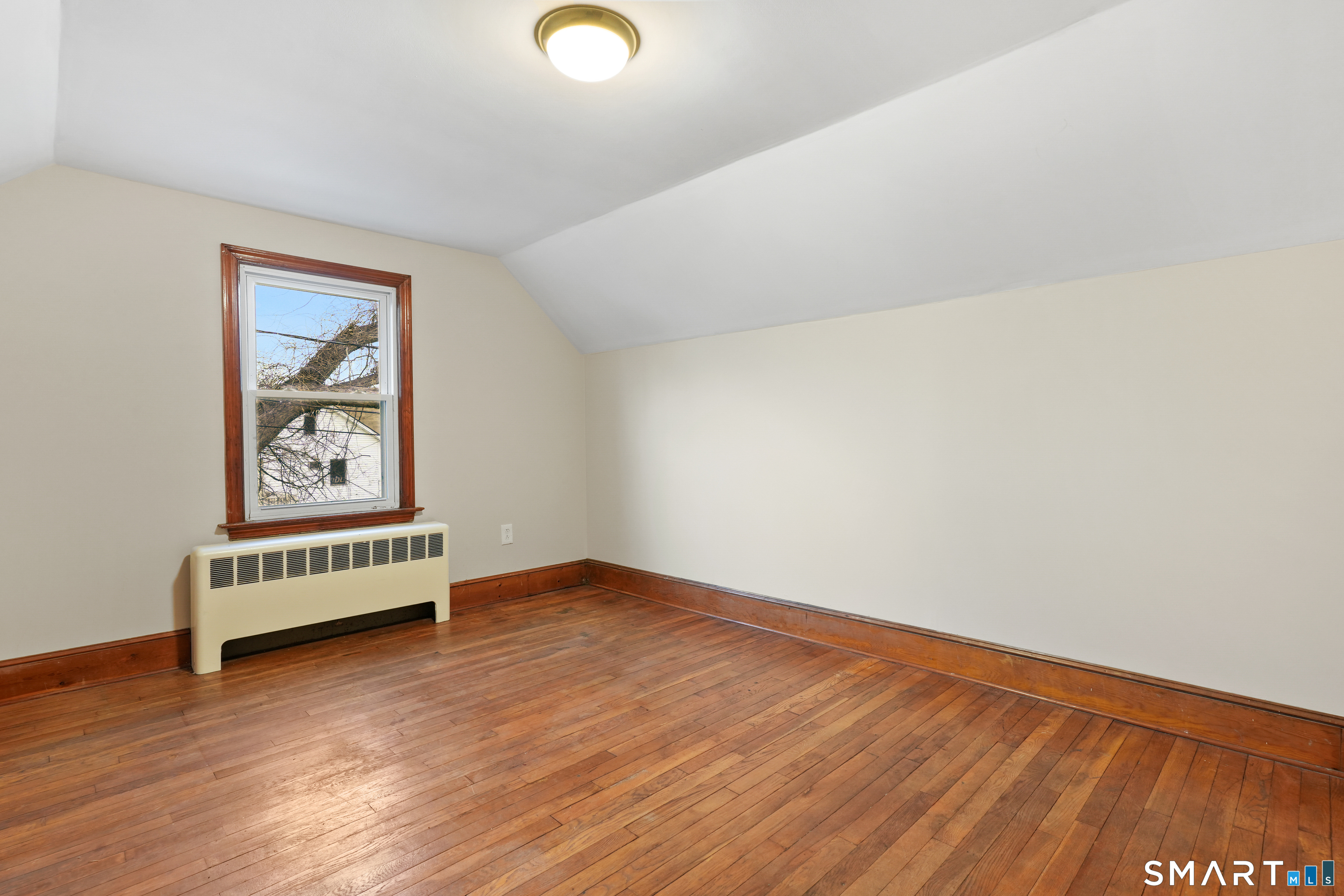 56 Beaver Brook Road Danbury, CT 06810 - Photo 15 of 38 a view of an empty room with wooden floor and a window