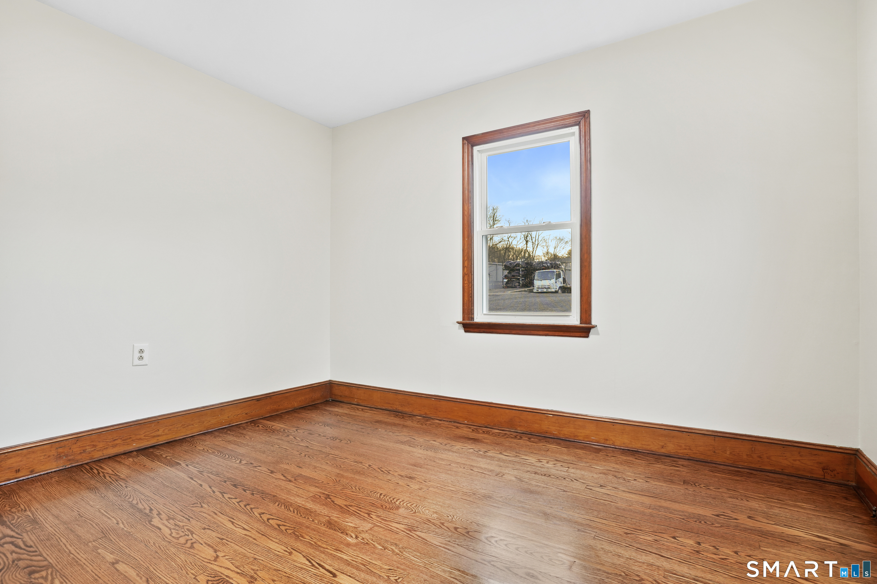 56 Beaver Brook Road Danbury, CT 06810 - Photo 19 of 38 a view of an empty room with wooden floor and a window