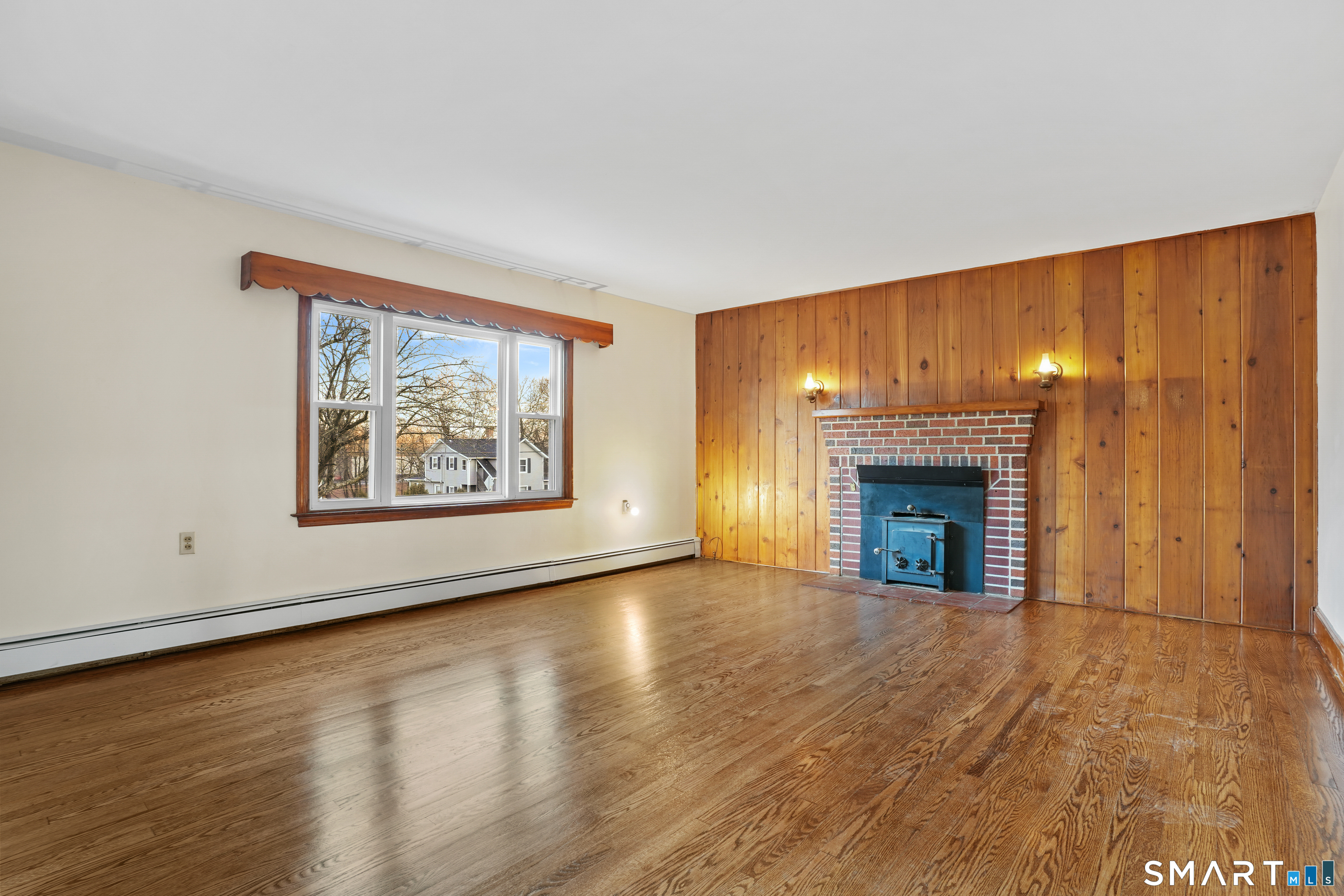 56 Beaver Brook Road Danbury, CT 06810 - Photo 2 of 38 an empty room with floor to ceiling window and fireplace