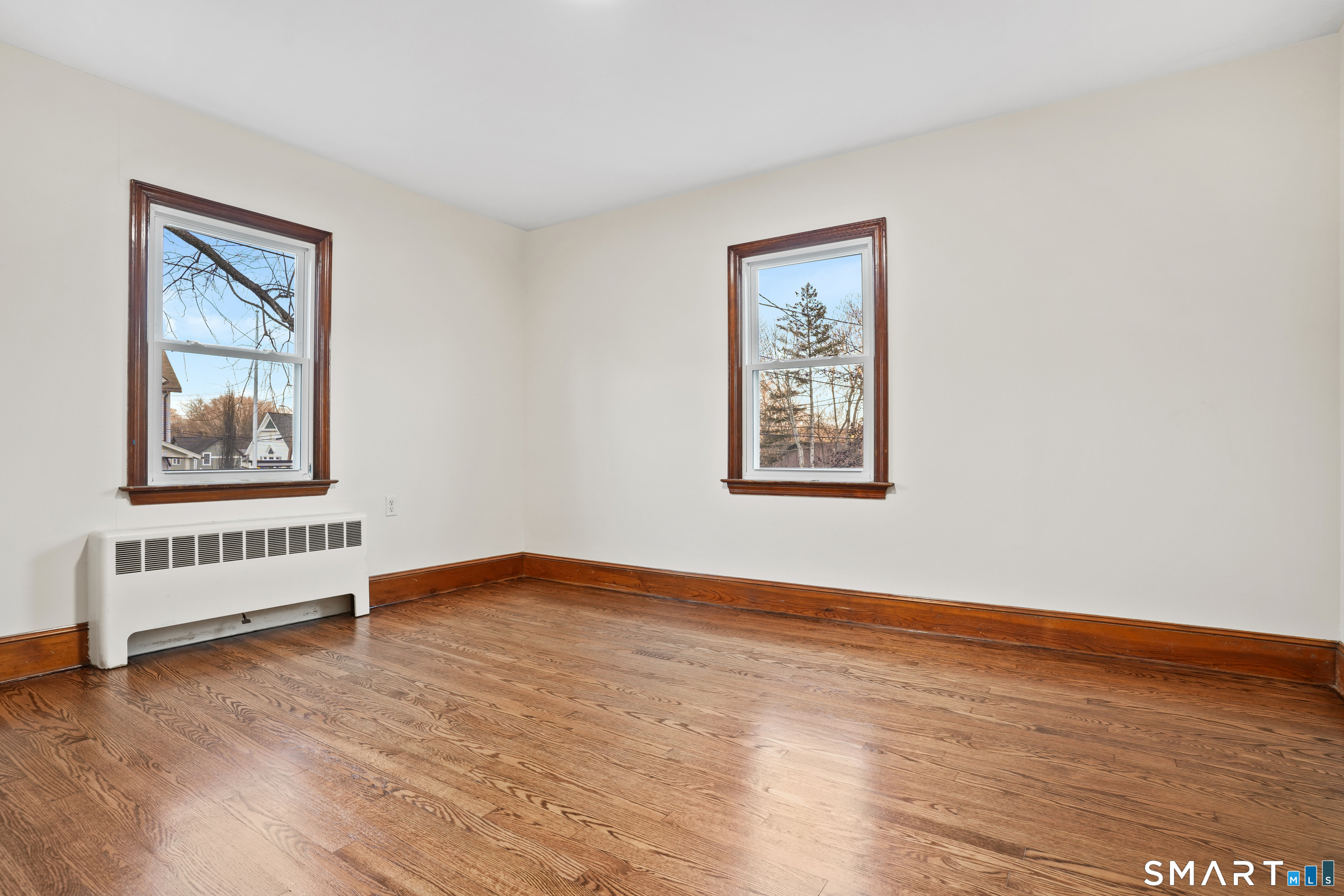 56 Beaver Brook Road Danbury, CT 06810 - Photo 21 of 38 a view of an empty room with window and wooden floor