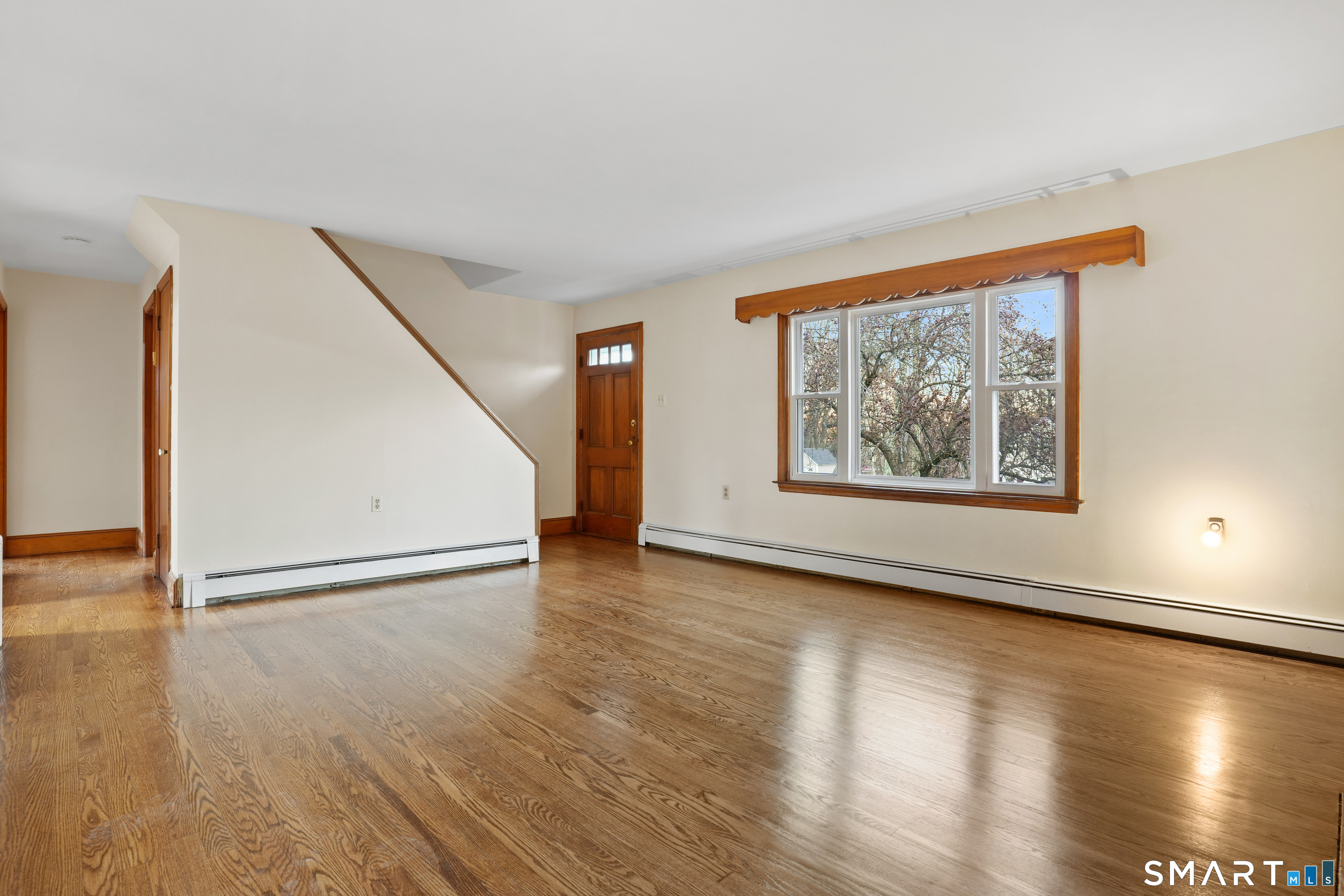 56 Beaver Brook Road Danbury, CT 06810 - Photo 3 of 38 a view of an empty room with wooden floor and a window