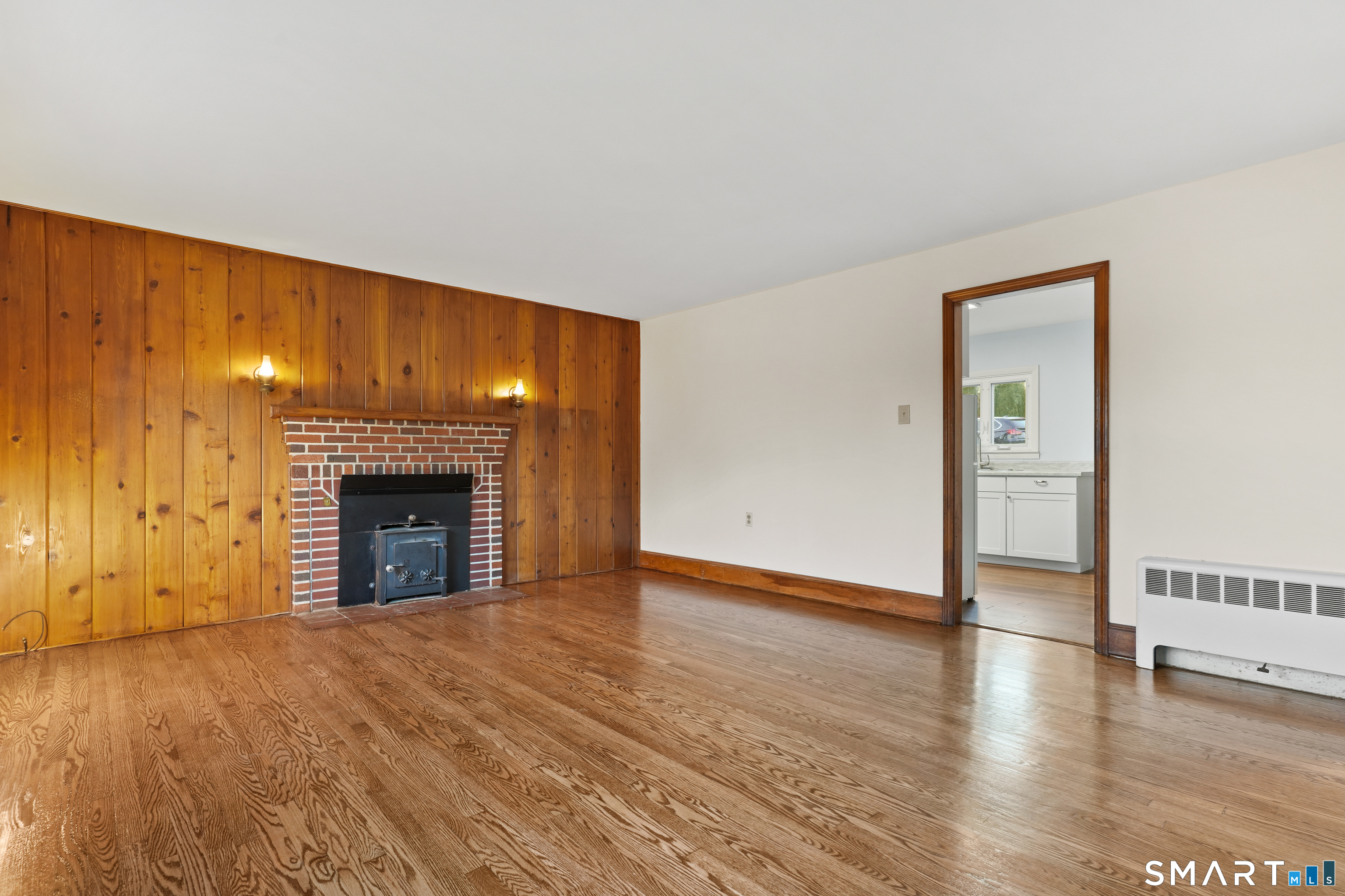 56 Beaver Brook Road Danbury, CT 06810 - Photo 9 of 38 a view of an empty room with wooden floor fireplace and a window