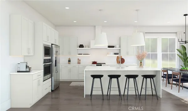 a kitchen with a table chairs refrigerator and cabinets