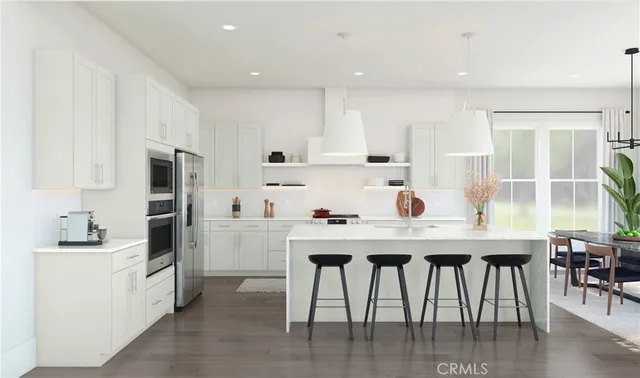 a kitchen with a table chairs refrigerator and cabinets