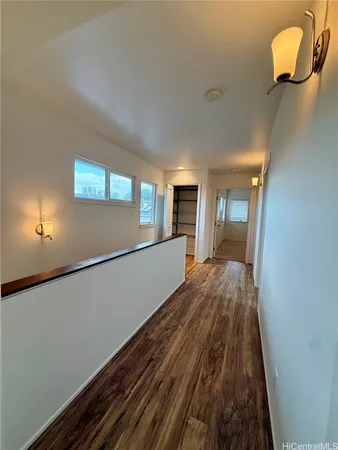 a view of a room with wooden floor and staircase