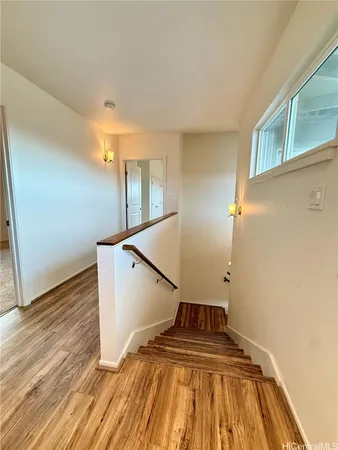 a view of a room with wooden floor and staircase