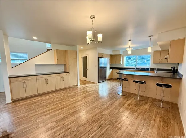 a kitchen with stainless steel appliances granite countertop a stove and a wooden floors