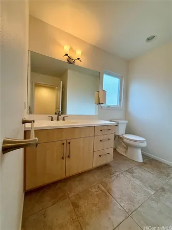 a spacious bathroom with a toilet sink and mirror