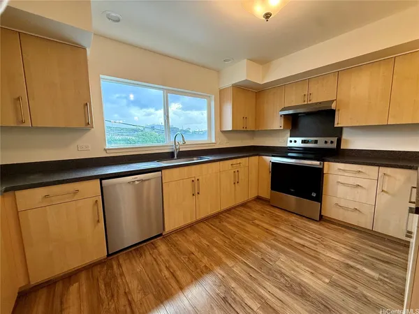 a kitchen with sink a microwave and cabinets