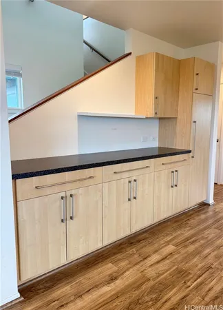 a view of a kitchen with wooden floor