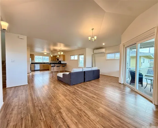 a view of a living room and kitchen with furniture wooden floor and windows