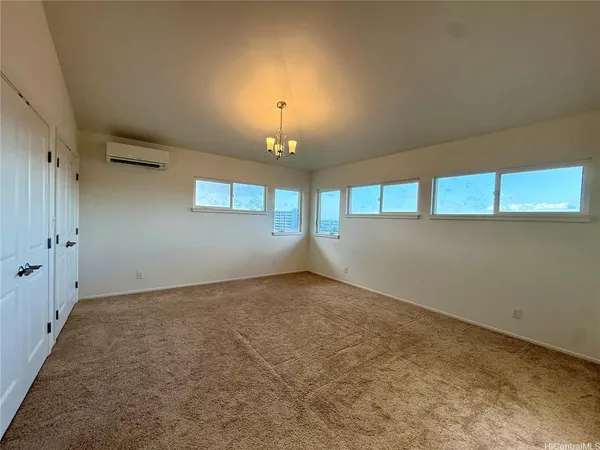 an empty room with a empty space and windows