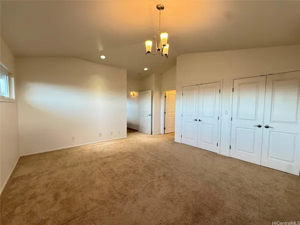 a view of an empty room with a chandelier