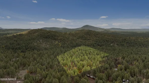 a view of mountain with sunset in background