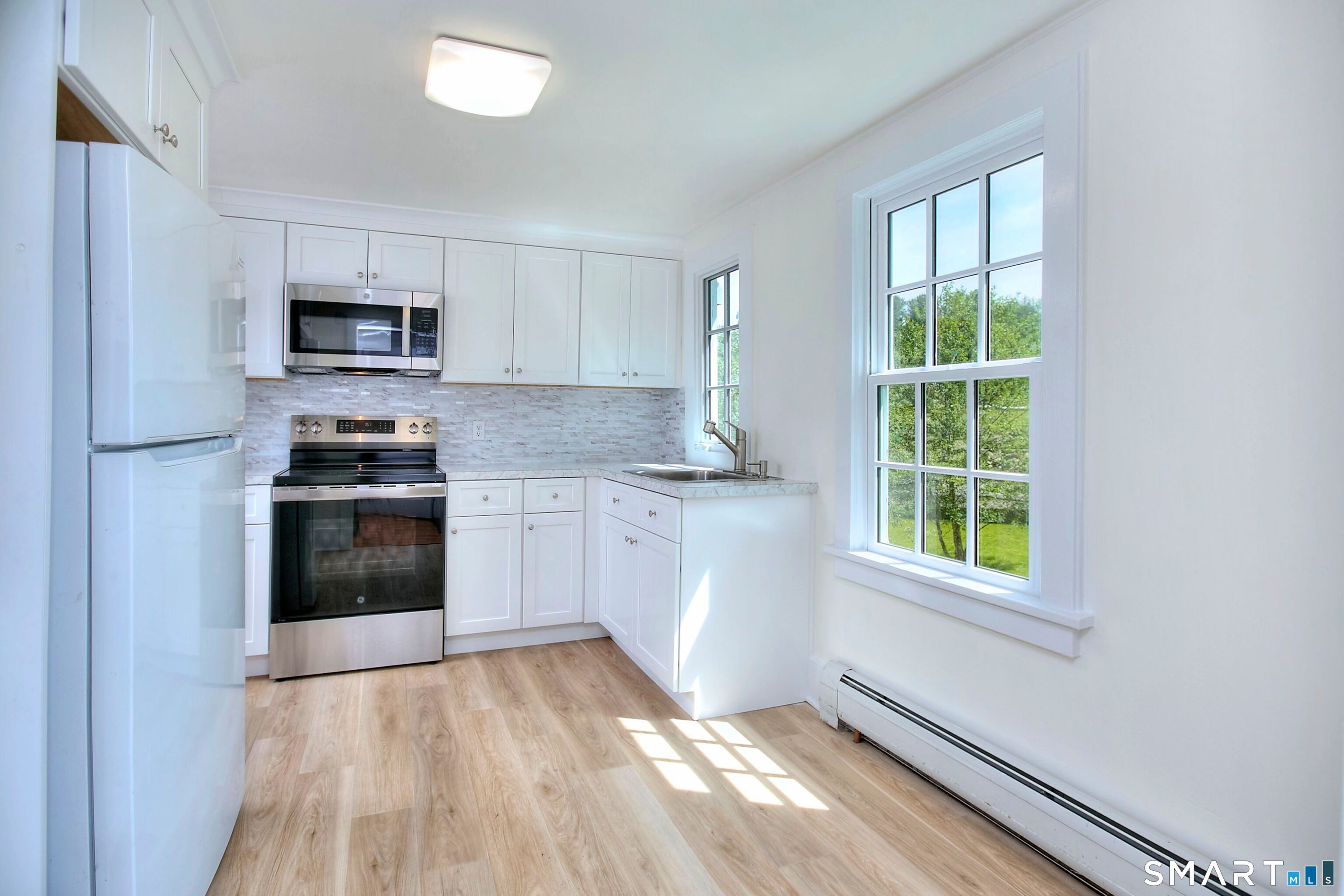 94 Honey Hill Road Wilton, CT 06897 - Photo 6 of 18 a kitchen with granite countertop a stove a sink and a microwave