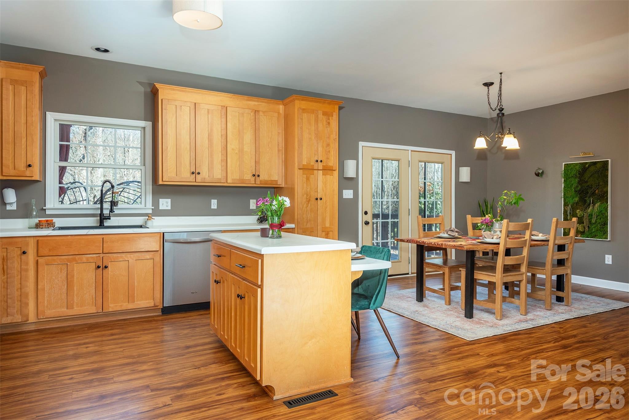 243 Scenic Ridge Drive Hendersonville, NC 28792 - Photo 11 of 47 a kitchen with a dining table chairs cabinets wooden floor and appliances