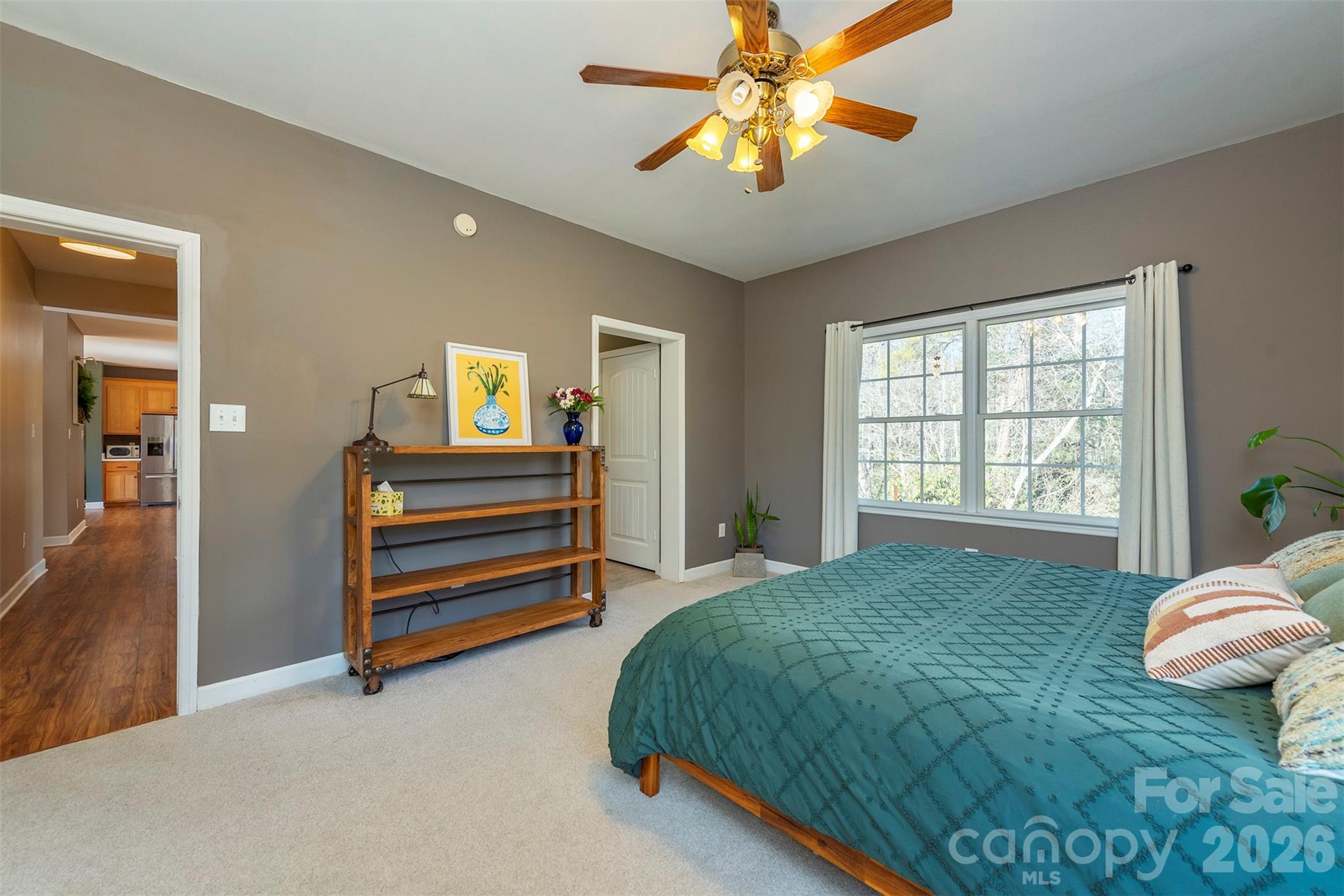 243 Scenic Ridge Drive Hendersonville, NC 28792 - Photo 19 of 47 a bedroom with a bed and a chandelier