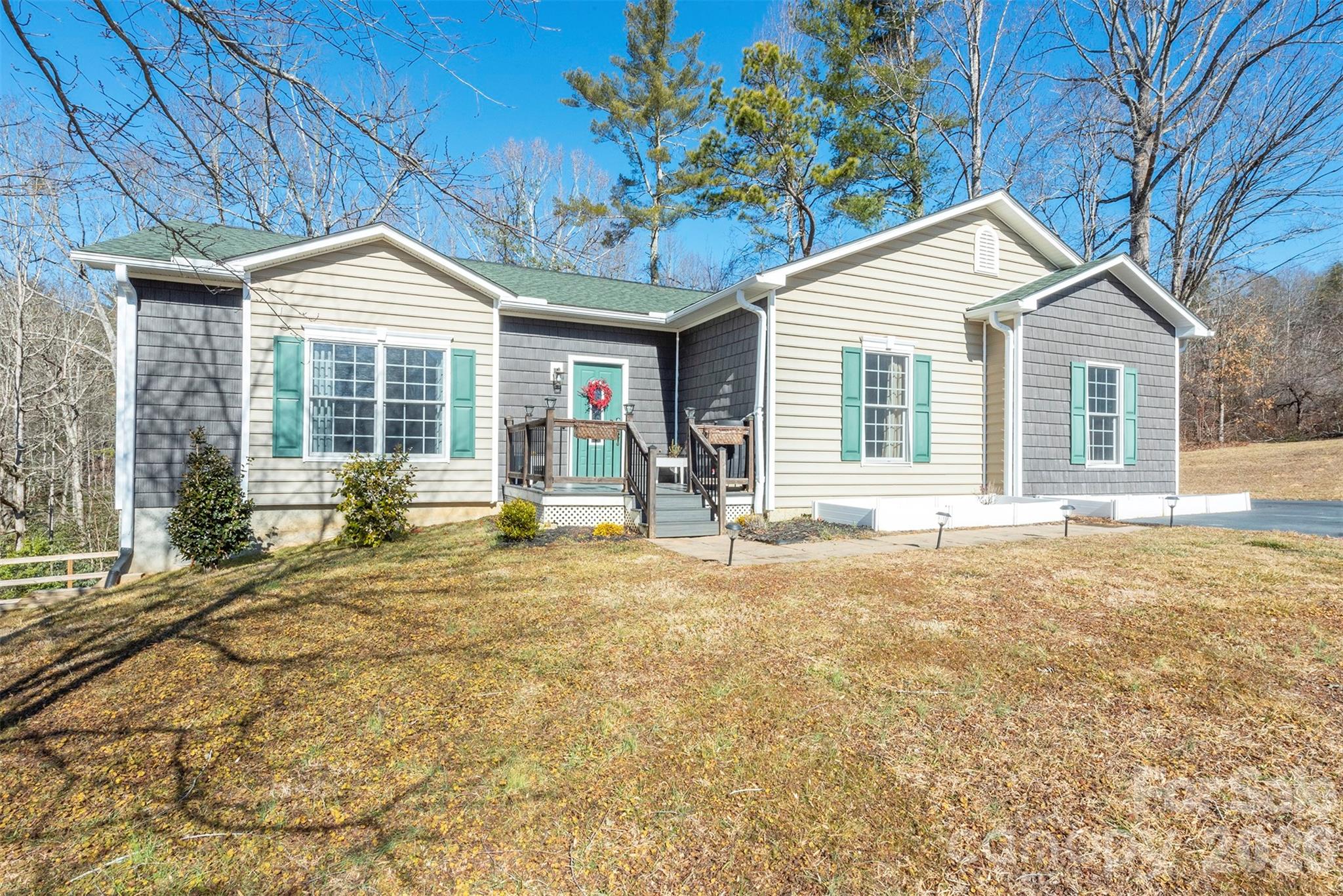 243 Scenic Ridge Drive Hendersonville, NC 28792 - Photo 2 of 47 a house with trees in the background