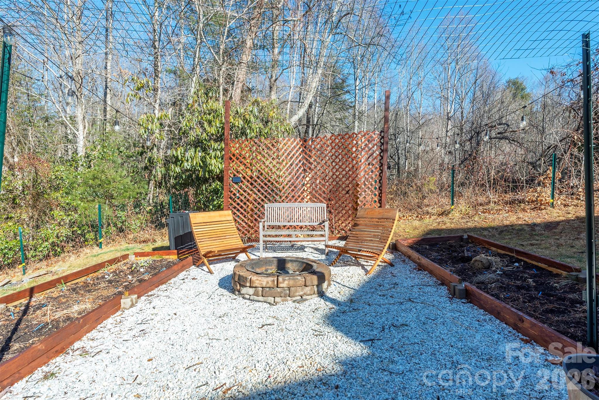 243 Scenic Ridge Drive Hendersonville, NC 28792 - Photo 36 of 47 a view of backyard with wooden fence and trees