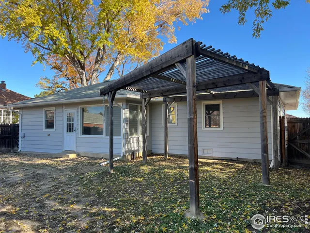 a view of backyard with wooden fence