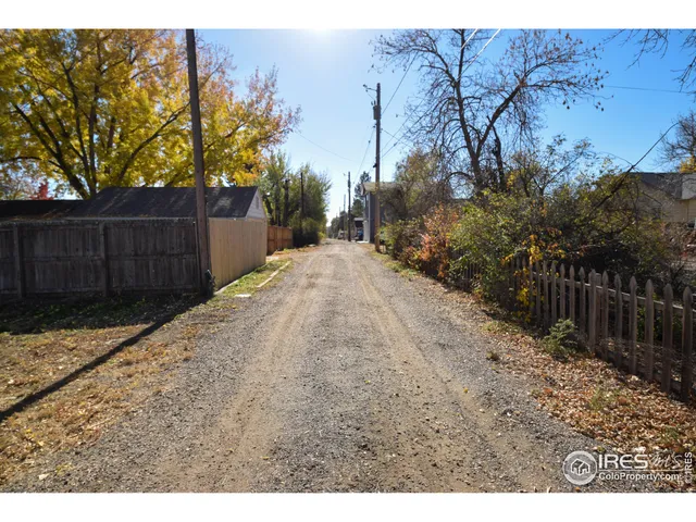 a view of a park with of trees with wooden fence