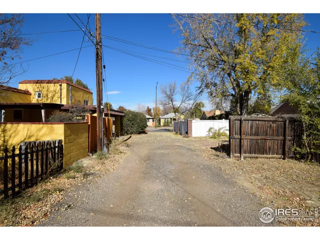 a view of a swimming pool with a patio and plants