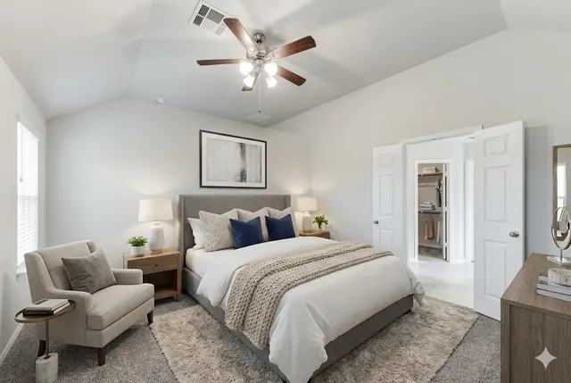 a bedroom with a large bed and a couch