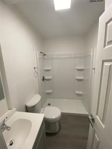 a bathroom with a sink toilet and shower