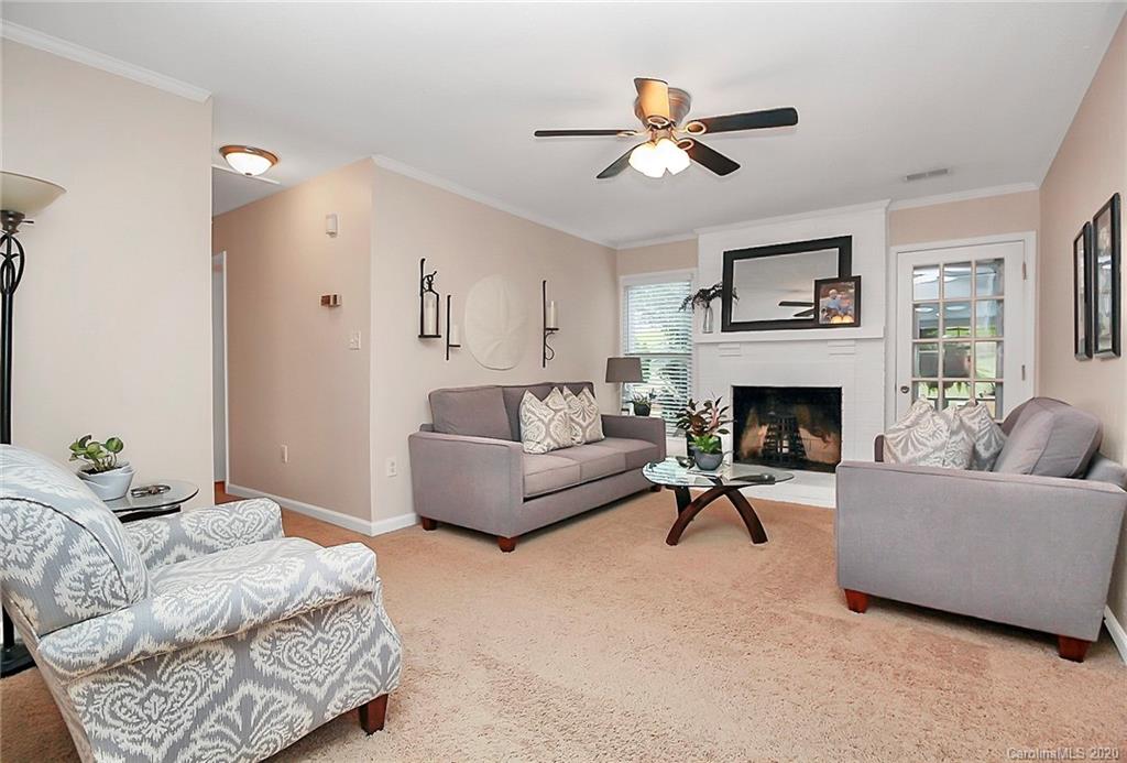 11412 Painted Tree Road Charlotte, NC 28226 - Photo 22 of 45 a living room with furniture and a fireplace