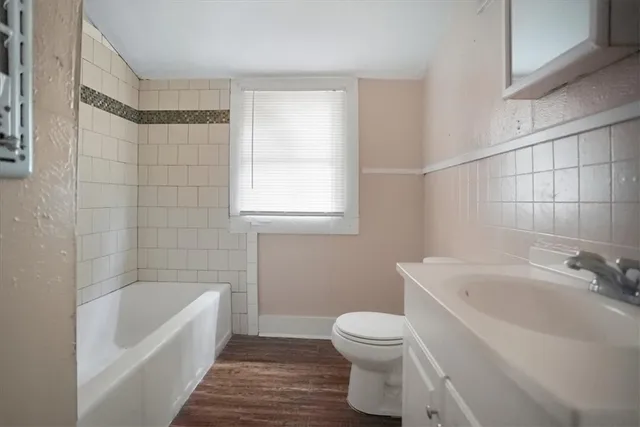 a bathroom with a sink a toilet and bathtub