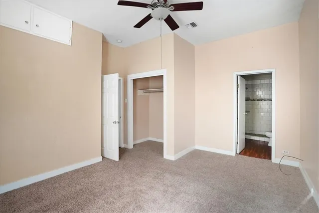 a view of empty room with ceiling fan