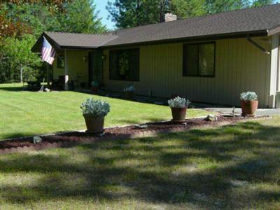 1801 Robertson Bridge Road Grants Pass, OR 97526 - Photo 1 of 1 a front view of a house with a yard
