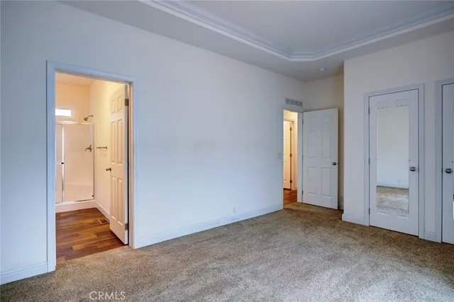 an empty room with closet and a bathroom