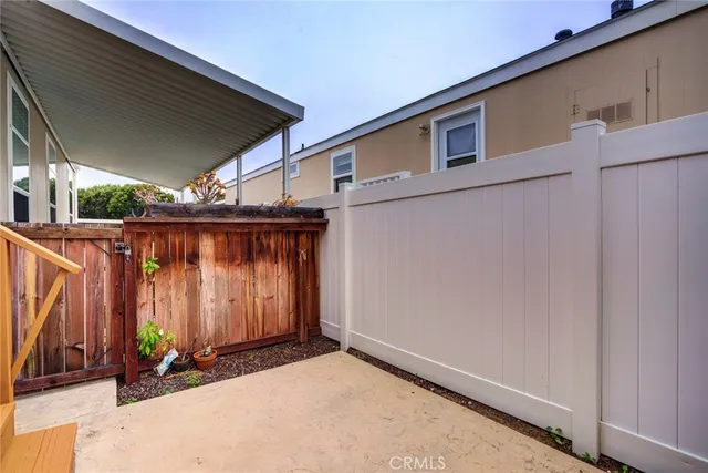 a view of a house with wooden fence