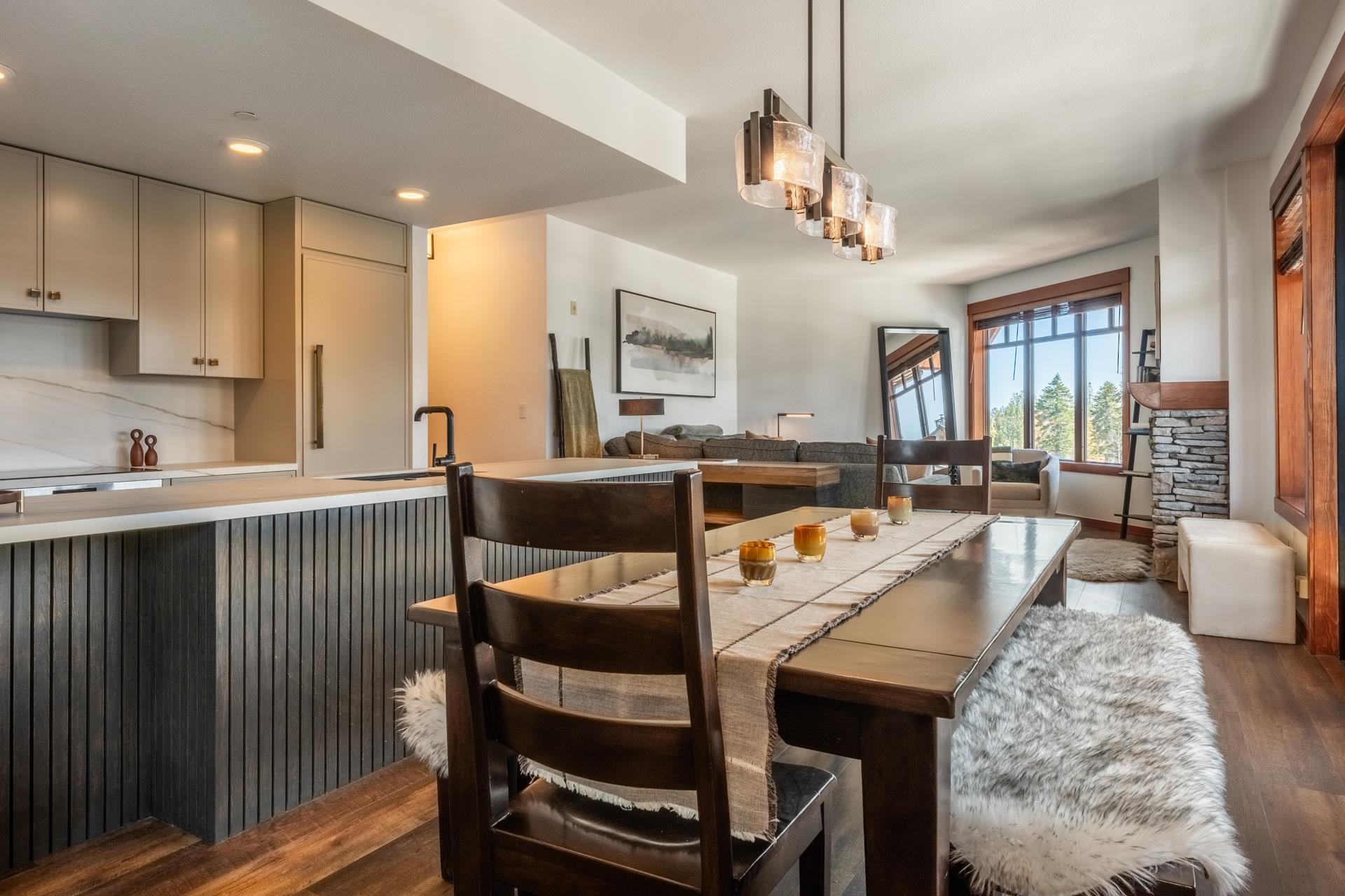 6201 Minaret Road, Unit 2430 Mammoth Lakes, CA 93546 - Photo 22 of 54 Kitchen island with waterfall edge stone countertop and fluted wood-finish paneling