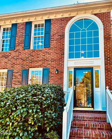 a view of a brick house with large windows