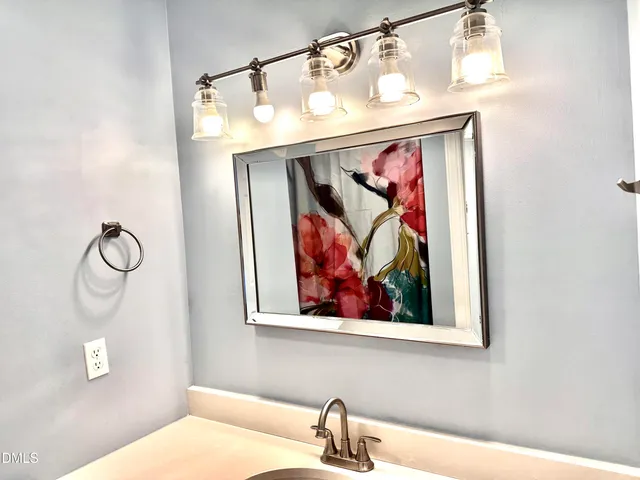 an empty room with chandelier fan and windows