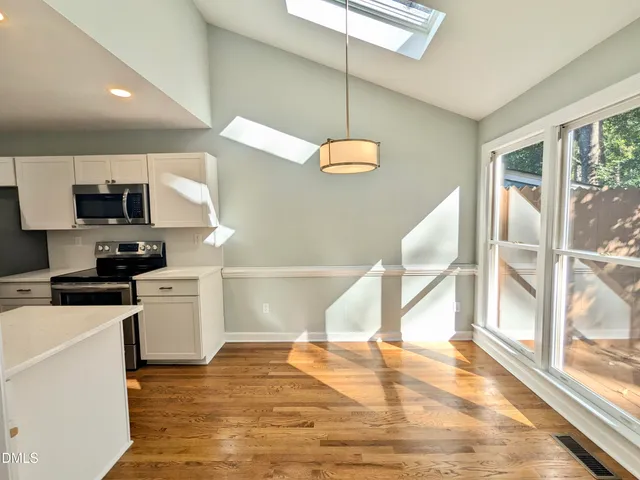 a kitchen with a sink a stove and microwave