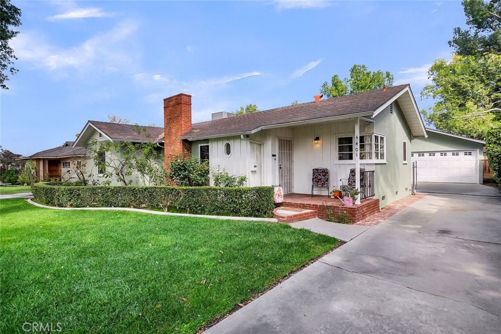 4401 Maplewood Place Riverside, CA 92506 - Photo 1 of 1 a front view of a house with a yard and potted plants