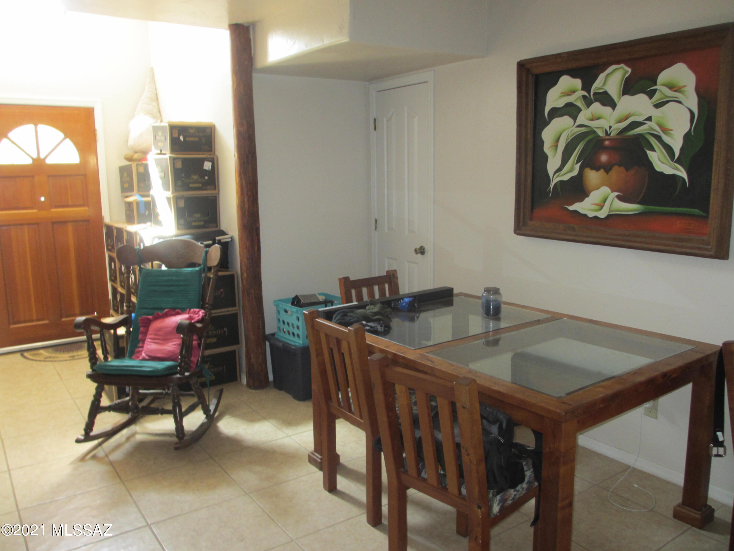 978 Calle Amarillo Rio Rico, AZ 85648 - Photo 22 of 34 a dining room with a wooden table and chairs