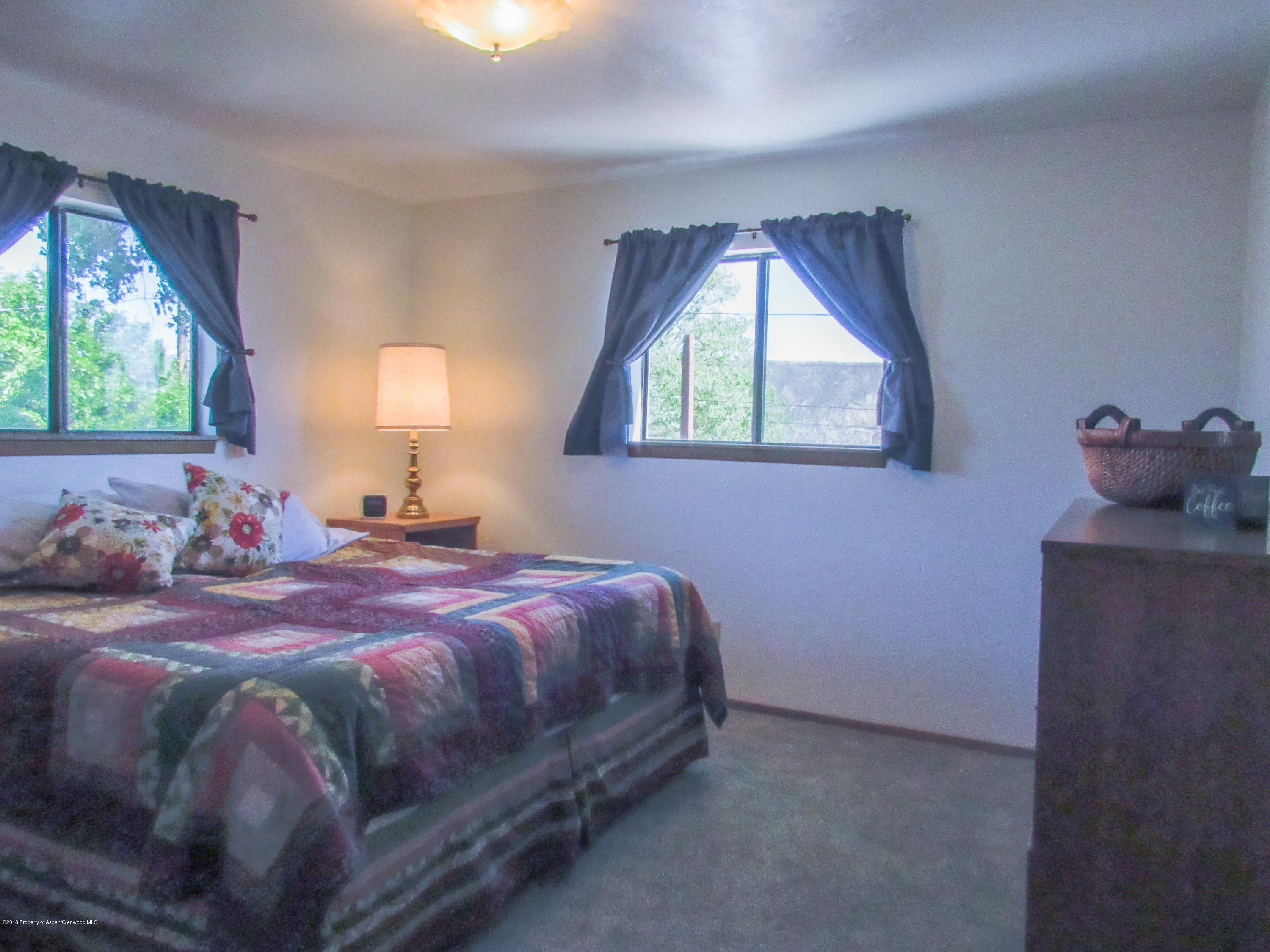 911 West 3rd Street Rifle, CO 81650 - Photo 17 of 29 a bedroom with a bed and window