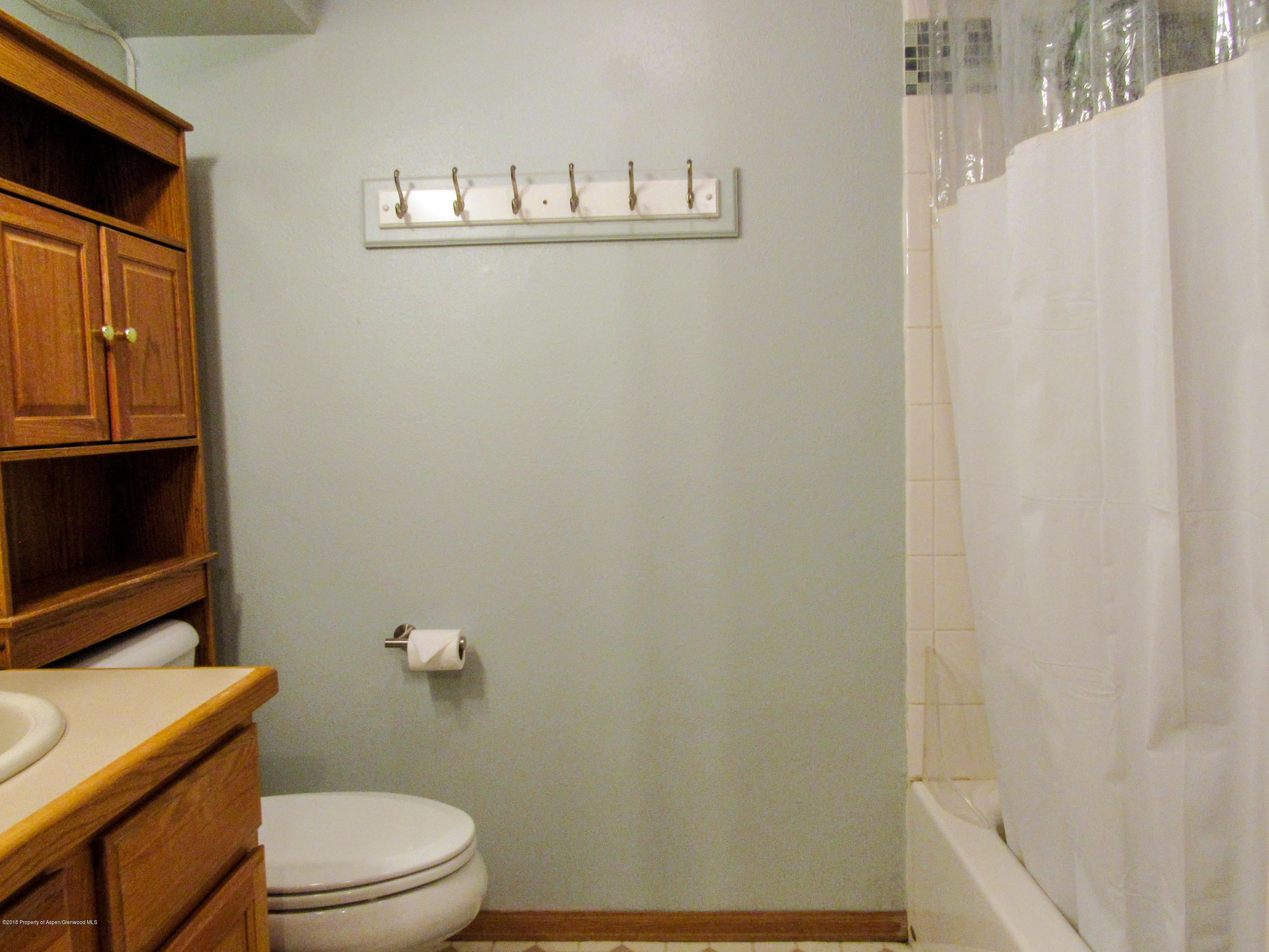 911 West 3rd Street Rifle, CO 81650 - Photo 19 of 29 a bathroom with a toilet a sink and a shower