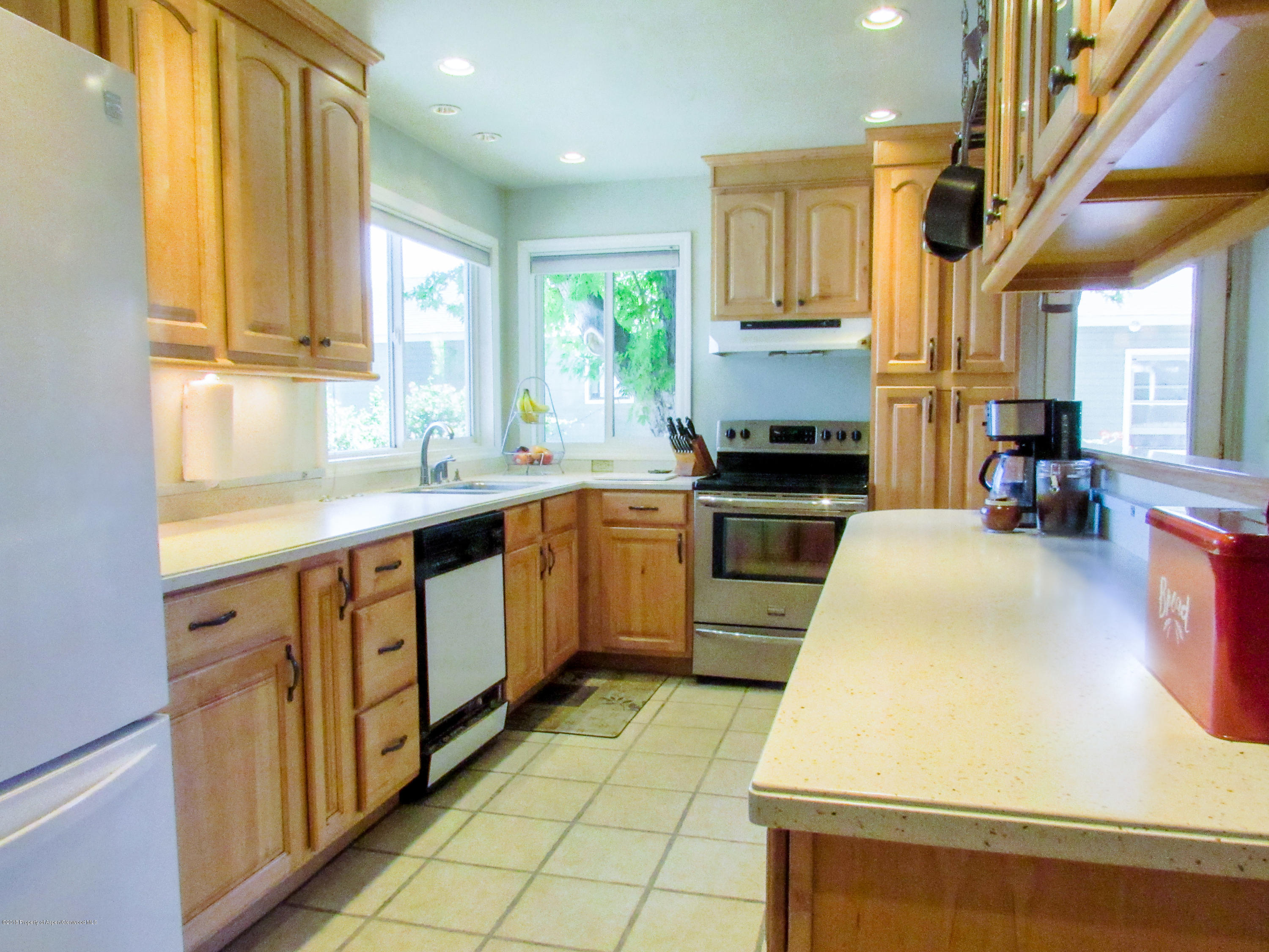 911 West 3rd Street Rifle, CO 81650 - Photo 7 of 29 a kitchen with a sink stainless steel appliances a window and a counter