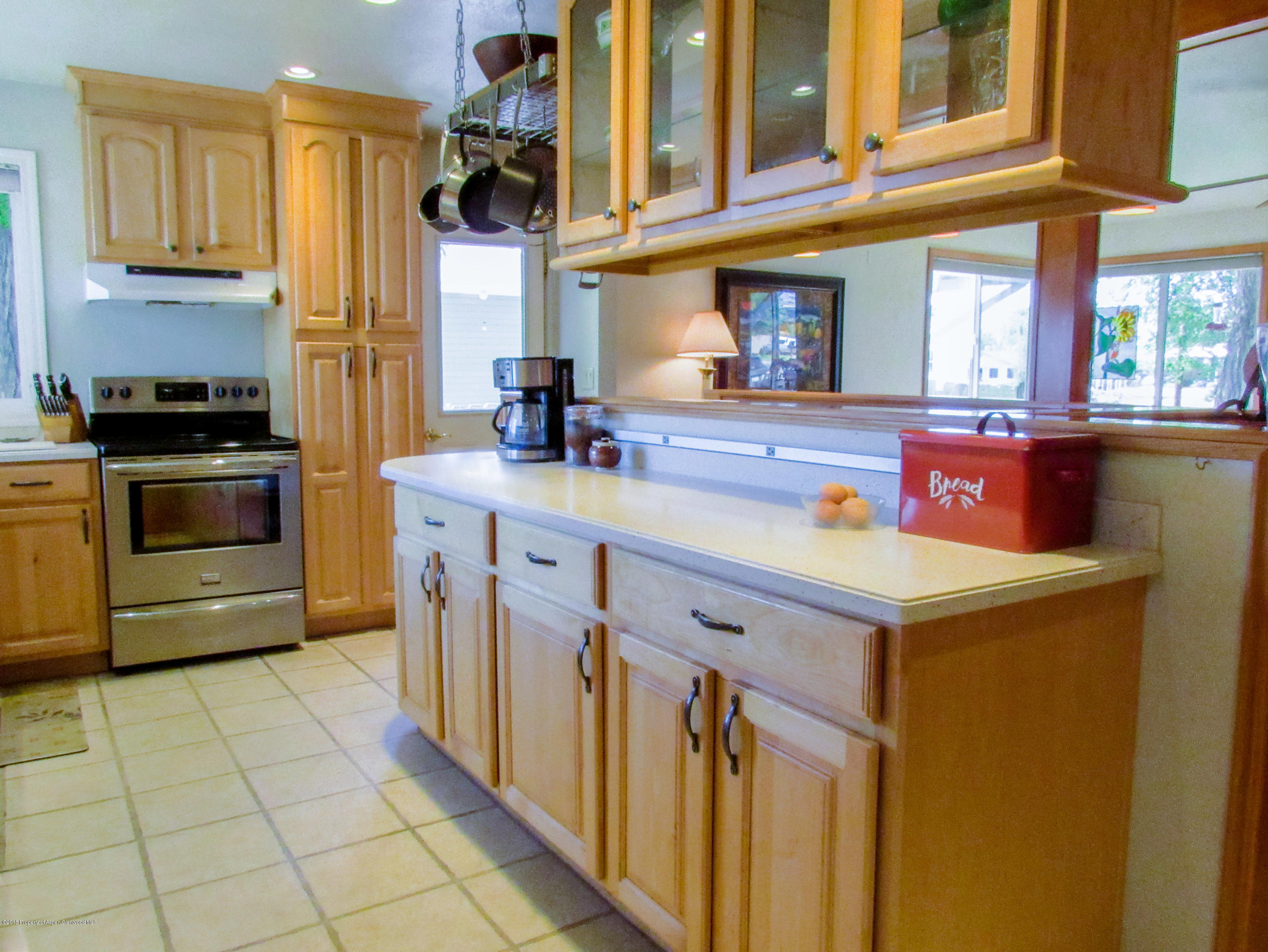 911 West 3rd Street Rifle, CO 81650 - Photo 8 of 29 a kitchen with stainless steel appliances granite countertop a sink and a stove