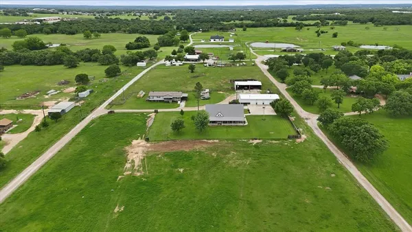 an aerial view of residential houses with outdoor space and river